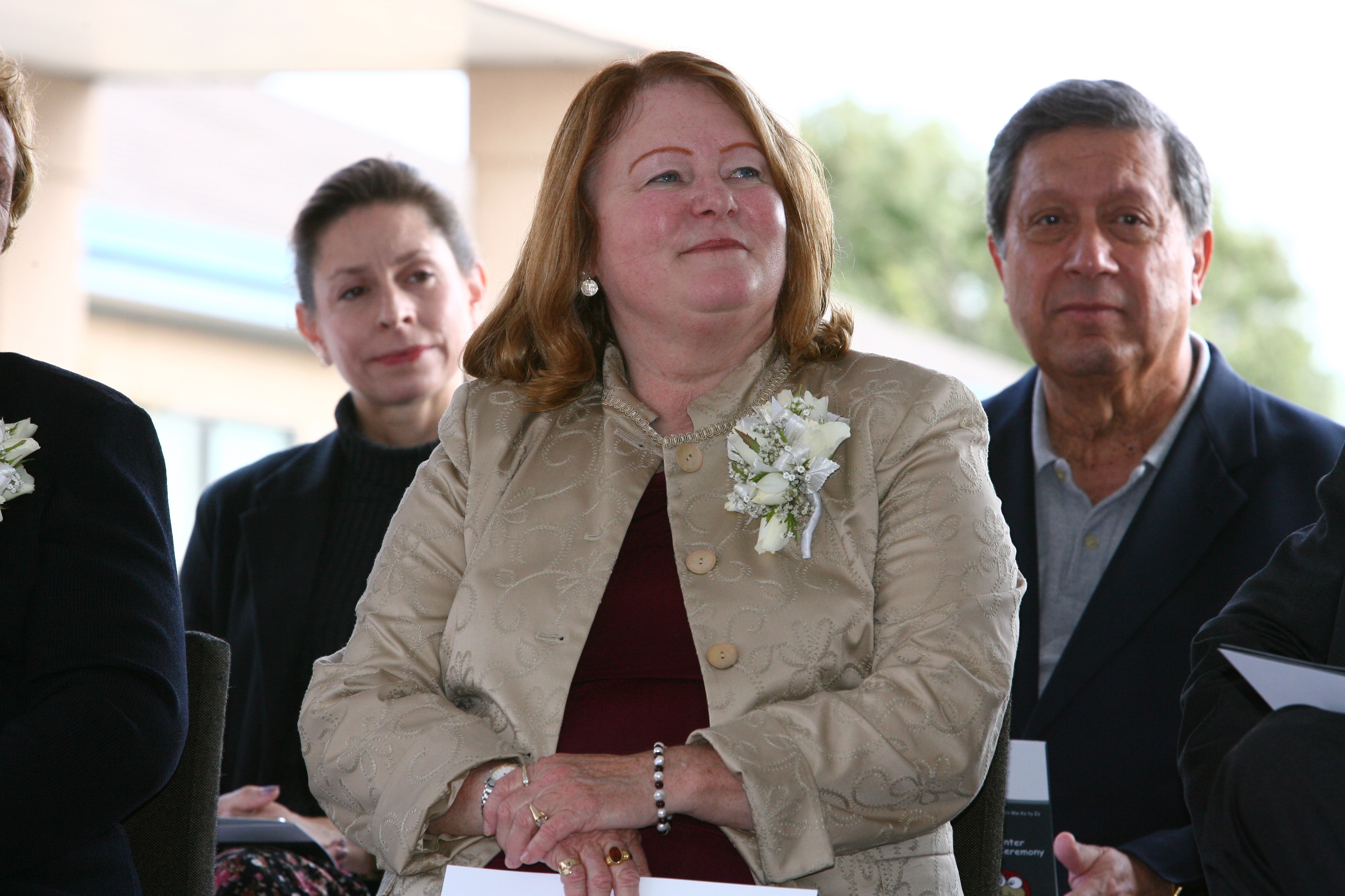 woman with red hair in silver jacket