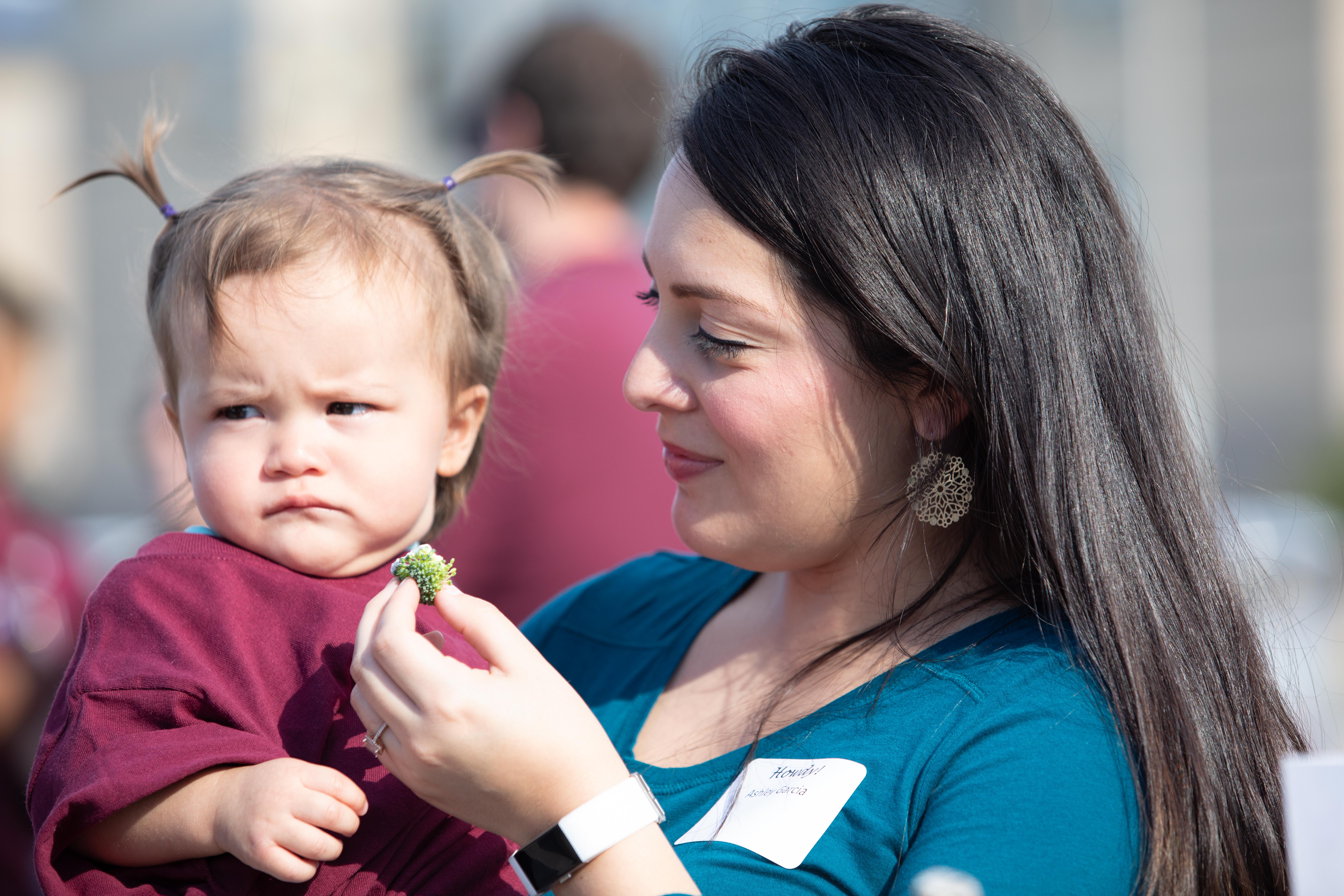 mother feeds her child