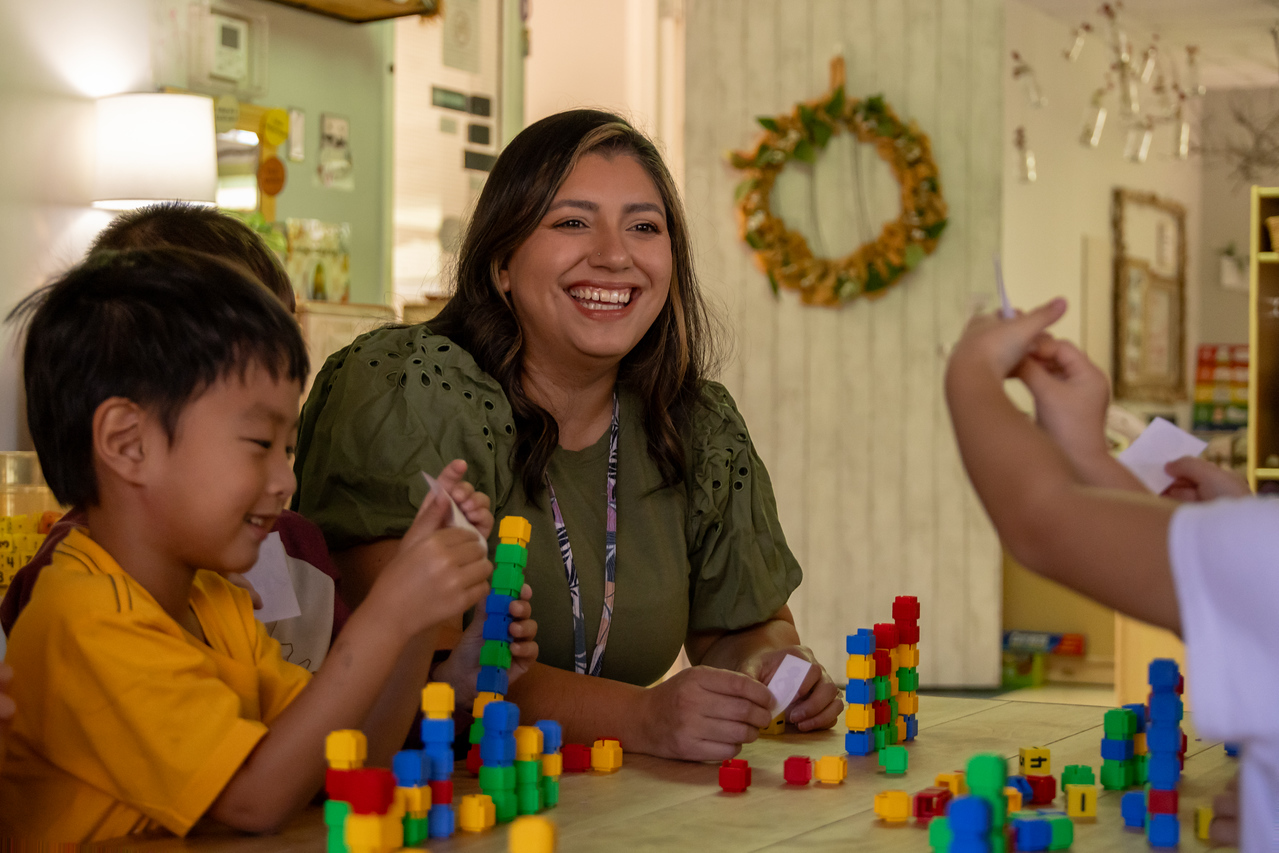 Texas A&M Children's Centers staff member working with kids.