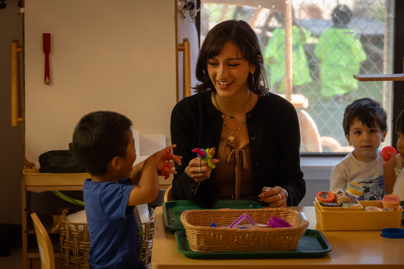Texas A&M Children's Center staff member working with kids.