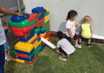 Group of kids playing with stackable blocks.
